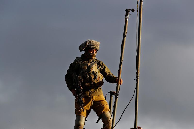 An Israeli soldier sets up a camera. AP Photo