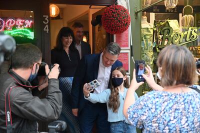 Britain's main opposition Labour Party leader Keir Starmer (C) poses for a selfie during a visit to local businesses in Hove, west of Brighton on the second day of the annual Labour Party conference in Brighton, on September 26, 2021.  AFP