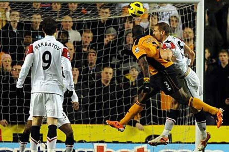 George Elokobi, second right, equalises for Wolves yesterday at Molineux.