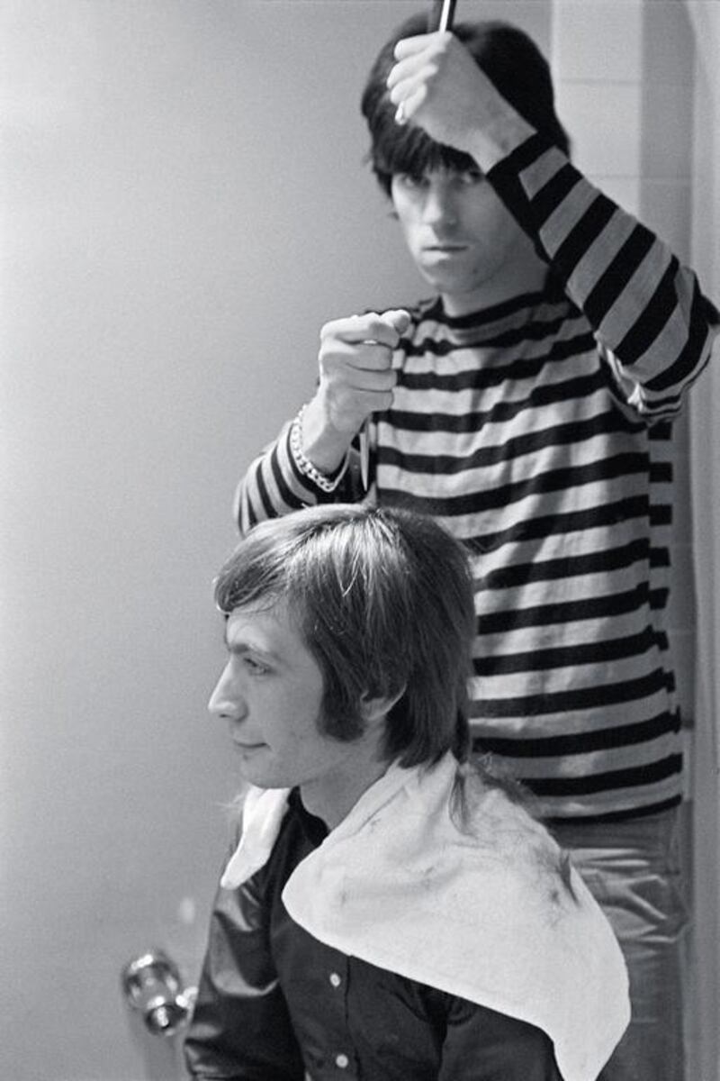 This November 11, 1965 shows Charlie Watts, left, receiving a haircut from Keith Richards of The Rolling Stones backstage before their appearance on the NBC teen music show Hullabaloo, in New York. AP Photo /Rock and Roll Hall of Fame and Museum, Bob Bonis