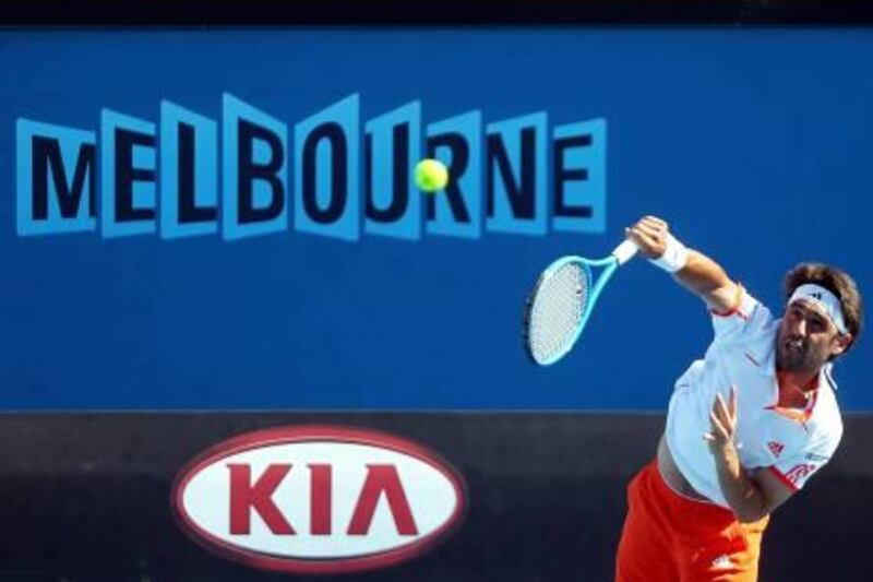 epa03062011 Marcos Baghdatis of Cyprus serves during his men's singles first round match against Benjamin Becker of Germany on the opening day of the Australian Open Grand Slam tennis tournament in Melbourne, Australia, 16 January 2012. Baghdatis won the match.  EPA/MAST IRHAM *** Local Caption ***  03062011.jpg