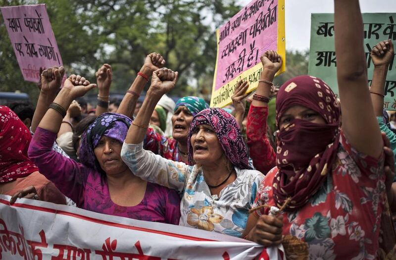 Indian Dalit women shout slogans during a protest against the gang rape of four Dalit girls in Haryana’s Hisar district in May 2014. Tsering Topgyal / AP