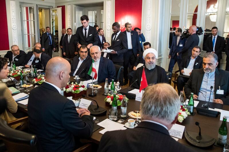 epa06860635 Swiss Federal President Alain Berset (2-L), Iranian President Hassan Rohani (2-R) and their delegation members sit at a table at the beginning of the delegation meeting, in Bern, Switzerland, 03 July 2018. Rouhani is on a two-days visit to Switzerland.  EPA/PETER KLAUNZER