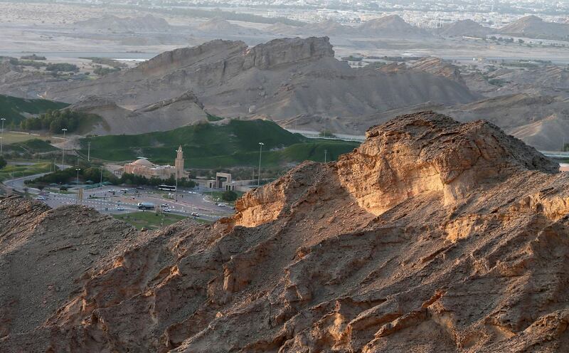 A general view taken on February 27, 2014, shows the Green Mubazarrah (centre) that lies at the foothills of the Jabal Hafeet moutain, which is primarily in the United Arab Emirates on the outskirts of Al-Ain, but straddles part of the border with Oman. The Green Mubazzarah is a popular tourist attraction due to its hot-water springs and wildlife. AFP PHOTO /KARIM SAHIB (Photo by KARIM SAHIB / AFP)