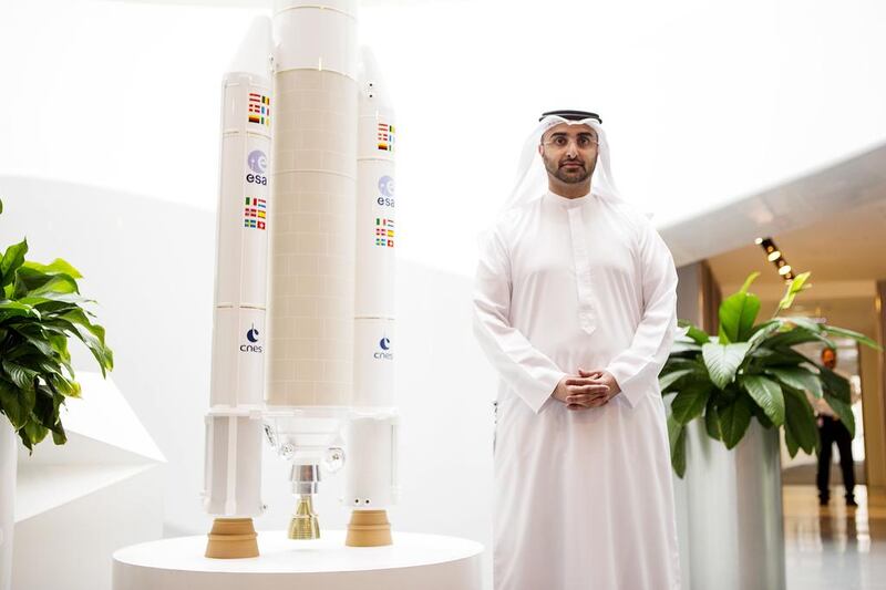 Masood Mahmood, the chief executive of Yahsat, stands next to a scale model of the Ariane V rocket which took the Y1A satellite into orbit in 2011. Christopher Pike / The National