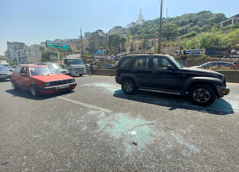 Shattered glass on the road where vehicles taking people to vote in Lebanon were attacked. Reuters