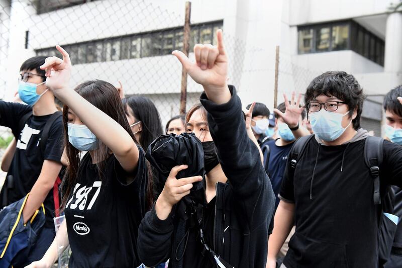 Protesters shout slogans as they gather outside the Eastern District Courts in Hong Kong. AFP