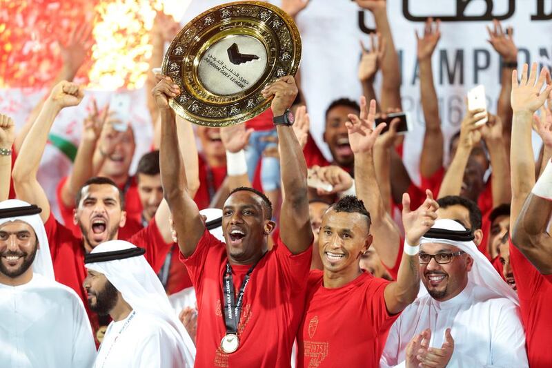 Al Ahli’s Ahmed Khalil (11) lifts the league trophy with Al Ahli’s Ciel (99) after defeating Al Shaab 5-0 during their final Arabian Gulf League match of the season, at Rashid Stadium in Dubai on May 8, 2016. Christopher Pike / The National