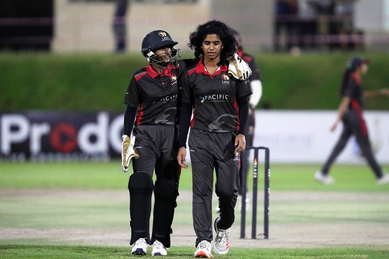 Theertha Satish, left, passes on instructions to UAE bowler Samaira Dharnidharka.