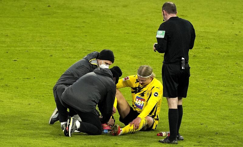 Dortmund's Erling Haaland receives assistance after being injured. EPA