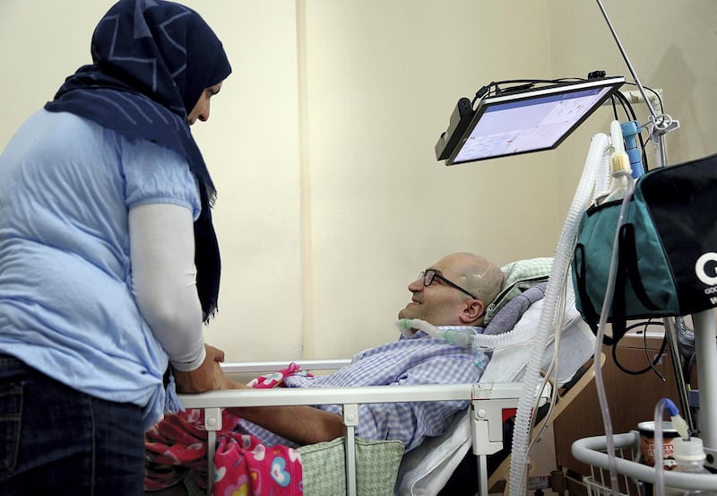 Sharjah, Feb, 24, 2018: Khaldoun Senjab who is paralyzed seen with is Wife Yusra Hilal  at his residence in Sharjah. Satish Kumar for the National / Story by Shareena Al Nuwais