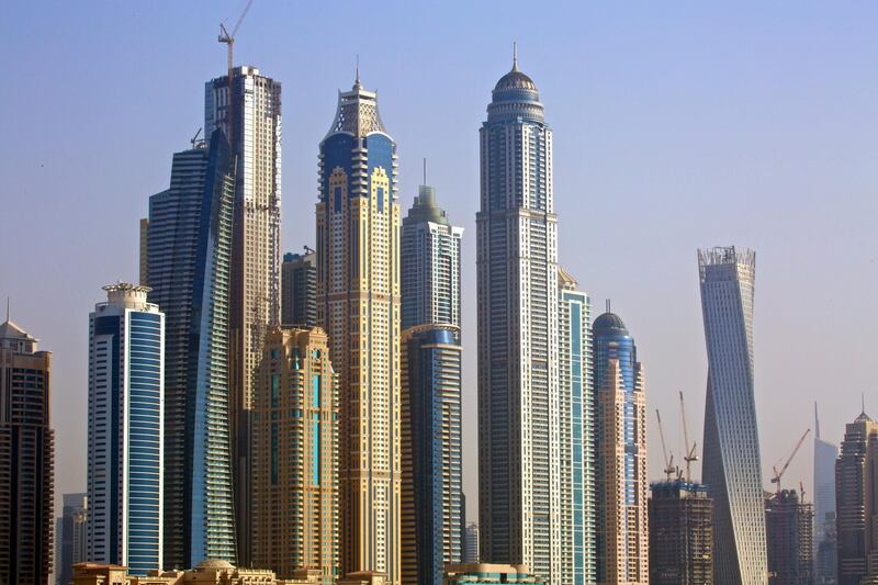 City skyscrapers stand on the waterfront seen from a construction site of residential apartments, operated by Skai Holdings LLC, on Palm Jumeirah artificial island in Dubai, United Arab Emirates, on Sunday, Aug. 31, 2014. Skai Holdings Chief Executive Officer Kabir Mulchandani's comeback caps a career that has tracked the twists and turns of a Dubai property market that’s now offering second chances to the investors and developers who stuck it out when others failed or fled in the aftermath of a 2008 crash. Photographer: Gilles Ledos/Bloomberg