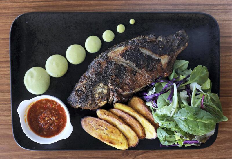 DUBAI, UNITED ARAB EMIRATES , Nov 6  – 2019 :- Grilled Tilapia dish at the Gbemi's Kitchen restaurant at the Al Waleed Paradise tower in JLT in Dubai. ( Pawan Singh / The National )  For Weekend. Story by Ashleigh Stewart