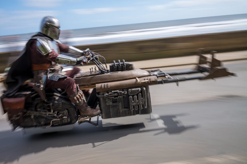 A Mandalorian and his speeder bike on the seafront in the North Yorkshire seaside town