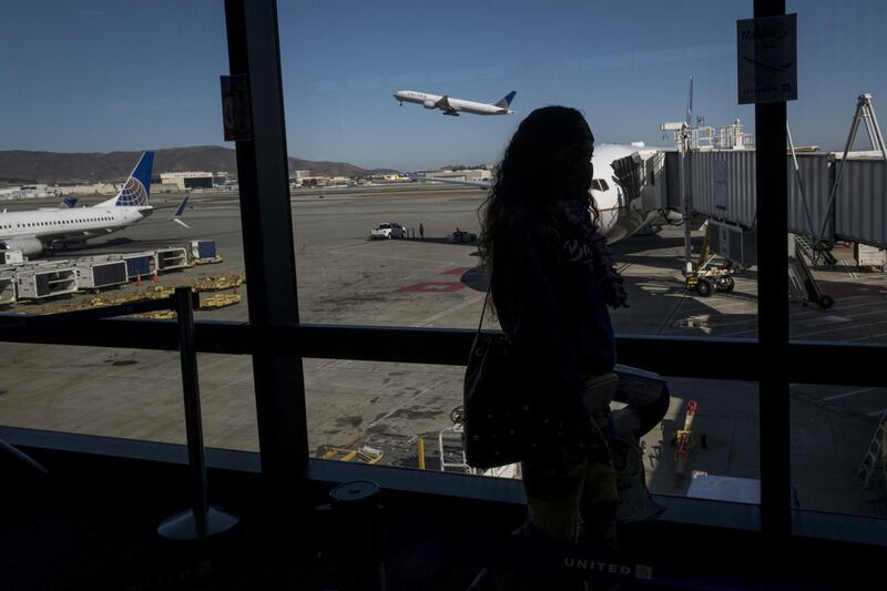 A traveller boards a United Airlines flight at San Francisco International Airport in California. Bloomberg