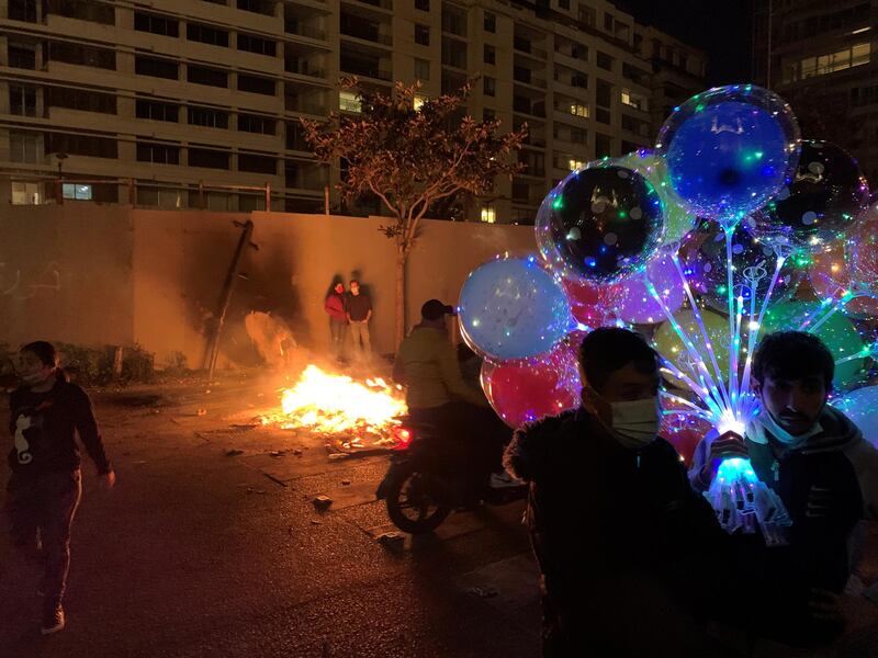 A street vendor holds his balloons during a protest against the fall in Lebanese pound currency and mounting economic hardship, in Beirut. Reuters