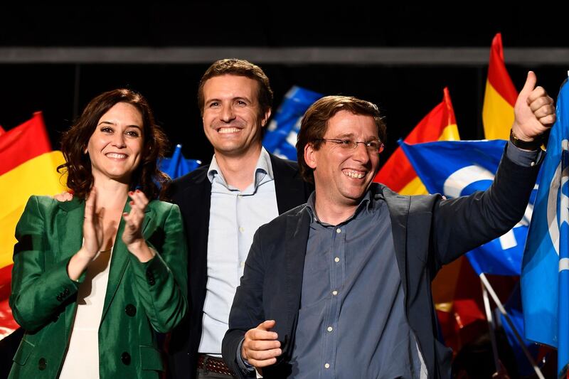 Leader of Spanish People's Party (PP), conservative Pablo Casado, centre, celebrates the election results with PP candidate to Madrid's regional government Isabel Diaz Ayuso and PP candidate to Madrid's mayoralty Jose Luis Martinez Almeida during an election night rally at the PP headquarters in Madrid. AFP