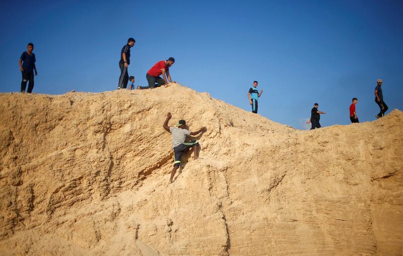 A Palestinian demonstrator climbs a hill during a protest in the northern Gaza Strip. Reuters