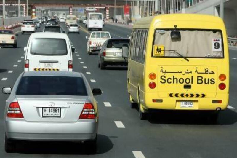 A school bus travels down Sheikh Zayed Road in Dubai. Parents are questioning whether the proposal for later school hours would affect bus fees. Pawan Singh / The National