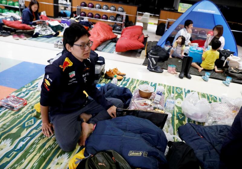 Formula One fan Kazuki Yoshida, 31, from Chiba Prefecture, who evacuated from Typhoon Hagibis, rests at a makeshift accommodation for spectators of the Formula One Japanese Grand Prix at Suzuka Circuit in Suzuka, central Japan. Reuters