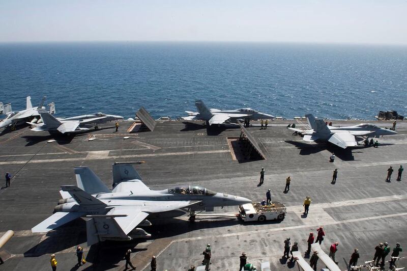 Aircraft are prepares for operations on the flight deck of the aircraft carrier USS Theodore Roosevelt on May 19, 2015, in the Gulf region. D’Artanyan Ratley / US Navy / AFP