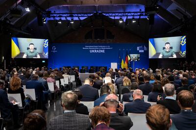 Delegates at the Berlin recovery summit listen to an address by Ukrainian President Volodymyr Zelenskyy. AP 