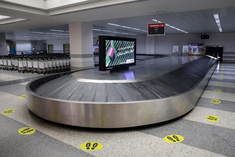 Social distancing markers sit on the floor around the baggage reclaim carousel in the arrivals hall at Rafik Hariri International Airport in Beirut. Bloomberg