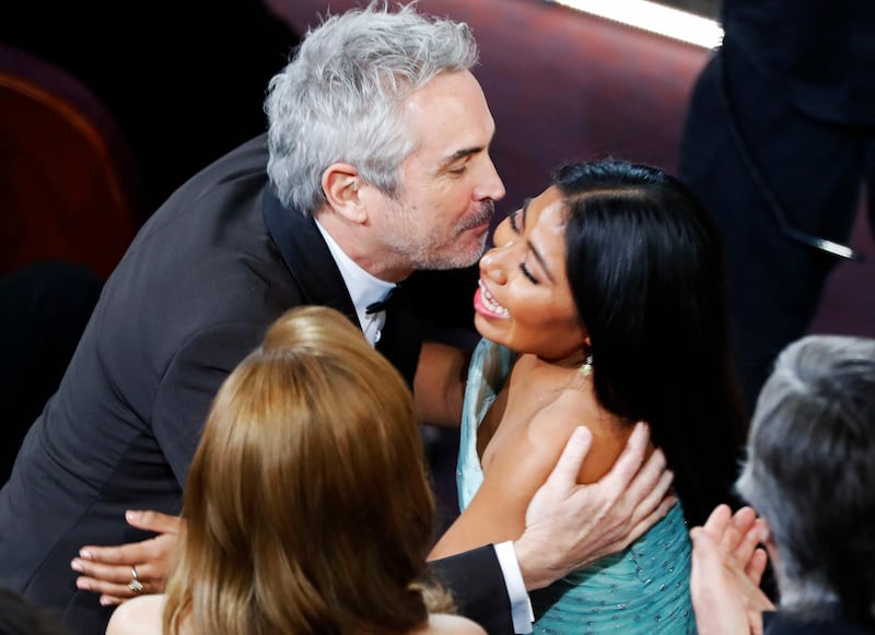 Alfonso Cuaron hugs Yalitza Aparicio as he accepts the Best Foreign Language Film award for 'Roma'. Photo: Reuters