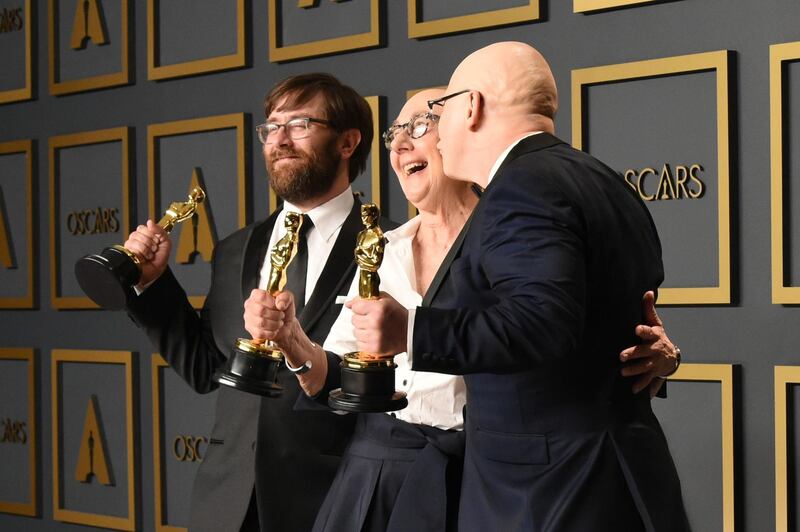 US directors Julia Reichert, Jeff Reichert (R) and Steven Bognar (L) pose in the press room with the Oscar for Best Documentary Feature for "American Factory" during the 92nd Oscars. AFP