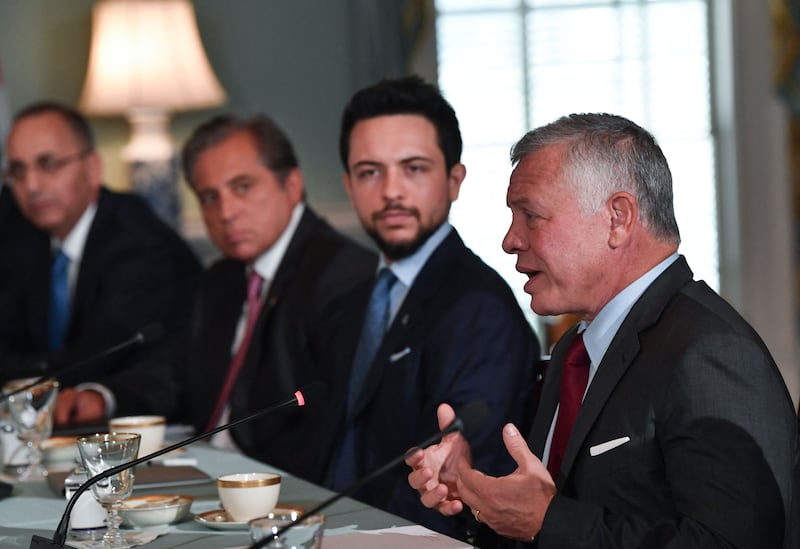 Jordan's King Abdullah speaks as Crown Prince Hussein looks on during a meeting with US Secretary of State Antony Blinken at the State Department in Washington.