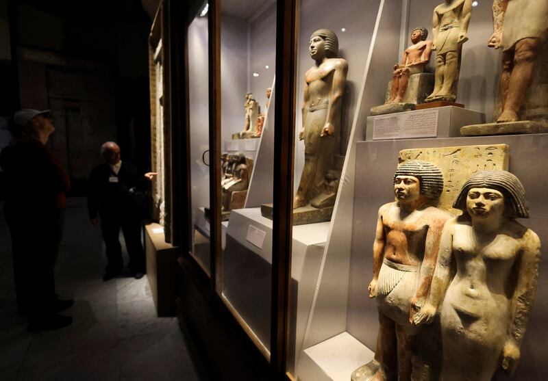 A museum guide explains artefacts to tourists in the Egyptian Museum in Cairo. Reuters