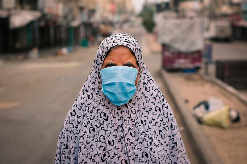 A Palestinian woman walks along a street in Gaza City. AFP