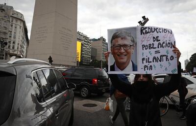 A woman holds a sing with the image of the Co-chair and Trustee of the Bill and Melinda Gates Foundation, Bill Gates, during a demonstration called by small businessmen affected by the government's mandatory quarantine imposed for more than 13 weeks, to protest against the quarantine and the expropriation of the Vicentin agro-industrial company on the Obelisk in Buenos Aires, June 20, 2020. Argentine President Alberto Fernandez announced on June 8 the nationalisation of soy giant Vicentin, which was the country's largest grain exporter until it entered a crisis at the end of last year. / AFP / ALEJANDRO PAGNI

