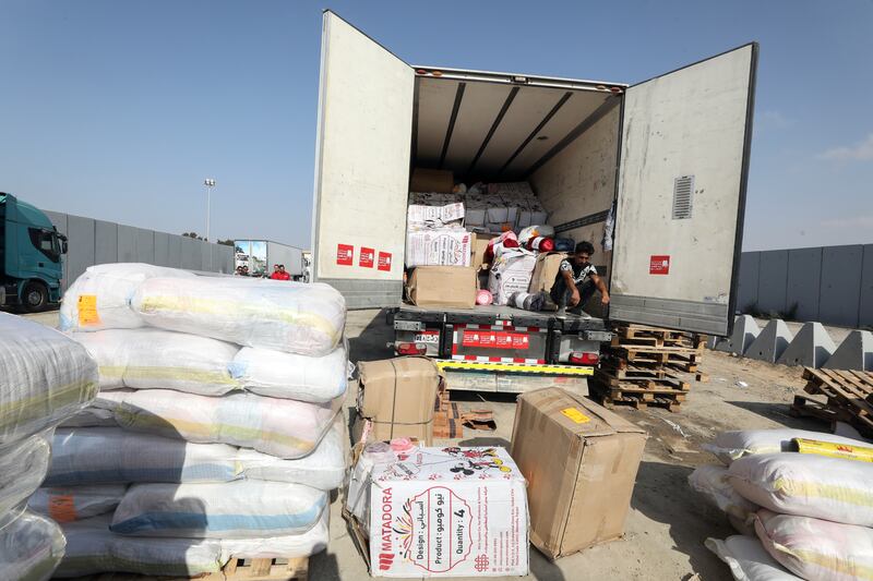 Egyptian volunteers handle humanitarian aid bound for Palestinians in the Gaza Strip, at the Rafah border crossing. EPA