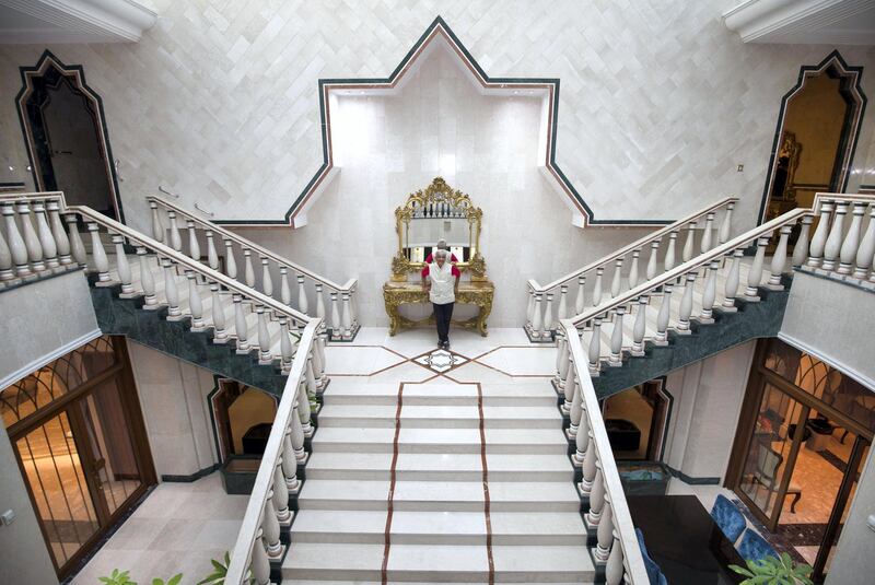 SHARJAH, UNITED ARAB EMIRATES, 20 JULY 2018 -Architect Ashok Mody at the grand staircase he designed for Sultan Sooud Al Qassemi 40 years ago at the villa of Sultan Sooud Al Qassemi, Sharjah.  Leslie Pableo for The National for Melissa Gronlund story