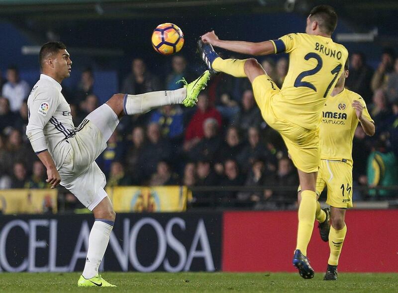 Real Madrid midfielder Casemiro, left, vies for the ball with Villarreal midfielder Bruno Soriano. Miguel Angel Polo / EPA