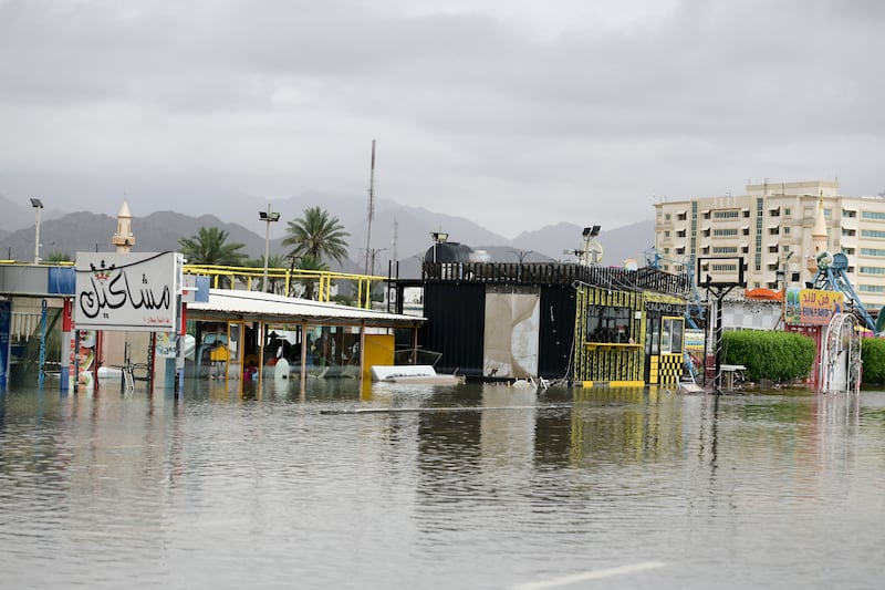 A food and entertainment area surrounded by water in Fujairah, after days of rain. Khushnum Bhandari / The National
