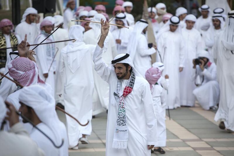 Students perform the traditional Yolla dance at Khalifa University in Abu Dhabi to mark the 42nd National Day. Silvia Razgova / The National