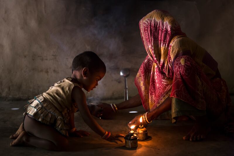 A young girl in West Bengal, India, plays with a kerosene flame inside a poor household in rural Bengal. More than six million Indian people suffer from fire burns every year, making India the burns capital of the world. These figures are related to the close proximity of housing in many areas, as well as the overwhelming use of an open flame for light, cooking and warmth. Despite these huge numbers, there are very few burns facilities for these victims and many are condemned to a painful, constricted life if they survive at all. Photo: Brent Stirton / Prix Pictet
