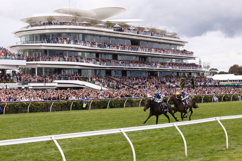 Mark Zahra riding Gold Trip leads Patrick Moloney riding Emissary to win the Melbourne Cup at Flemington Racecourse. Getty Images