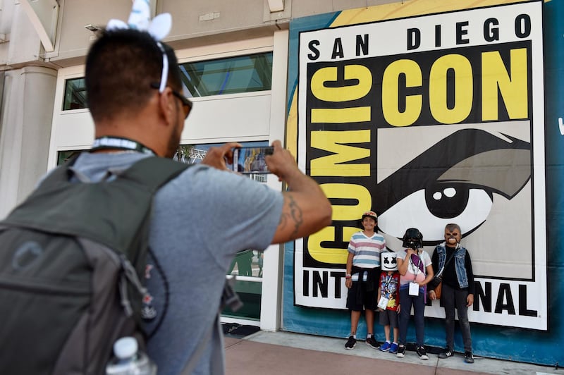 Luis Ramos, left, of San Diego takes a picture of his son Alek, 6, third from right, and daughter Anabel, 11, second from right, and their friends Emiliano Beltran, 12, fourth from right, and Isabel Beltran, 10, before Preview Night at the 2018 Comic-Con International at the San Diego Convention Center in San Diego, California, USA, on July 18, 2018. AP Photo