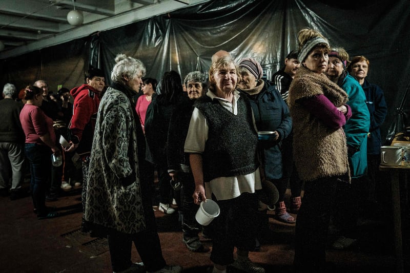 Internally displaced people wait for food to be distributed in a bunker at a factory in Severodonetsk, Ukraine.  AFP