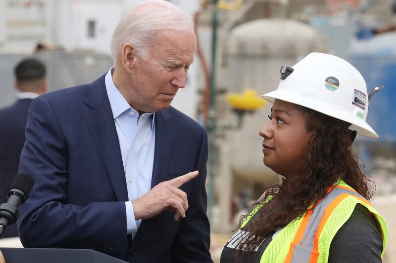 Mr Biden speaks with worker Yurvina Hernandez on his visit to Los Angeles. EPA