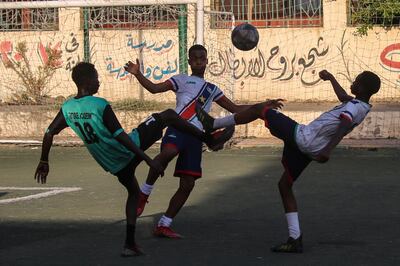 Young Sudanese footballers play a game in Cairo, Egypt. Getty Images.