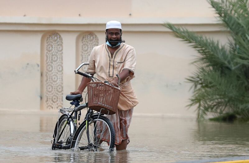 A man wades through a flooded street in Oman's capital Muscat. AFP