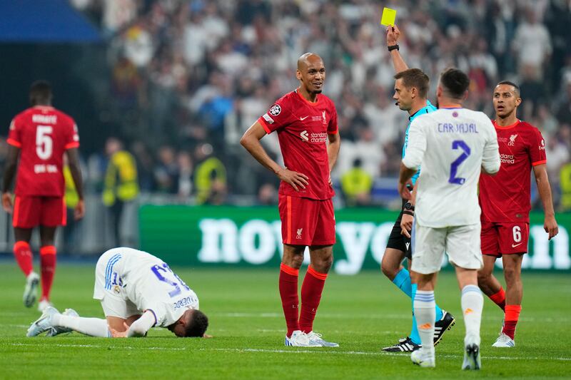 Liverpool midfielder Fabinho is shown a yellow card. AP
