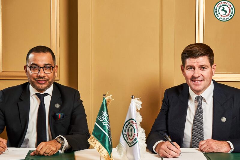 Steven Gerrard, right, signs his contract to become new Al Ettifaq manager in London alongside club president Khaled Al Dabal. AFP