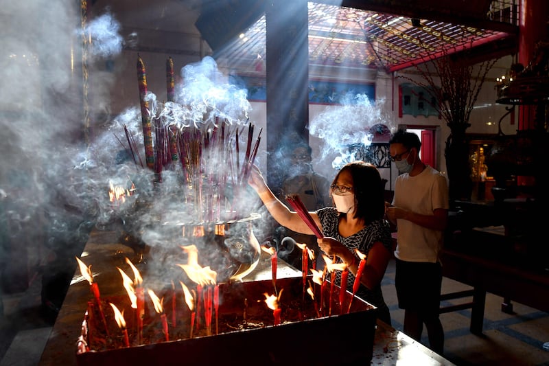 Burning incense sticks in Yangon's Chinatown. AFP