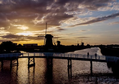 One of the hot topics at the moment is the impact of renewable energy projects, such as modern windmills on the Netherlands' 18th century Mill Network at Kinderdijk. AP