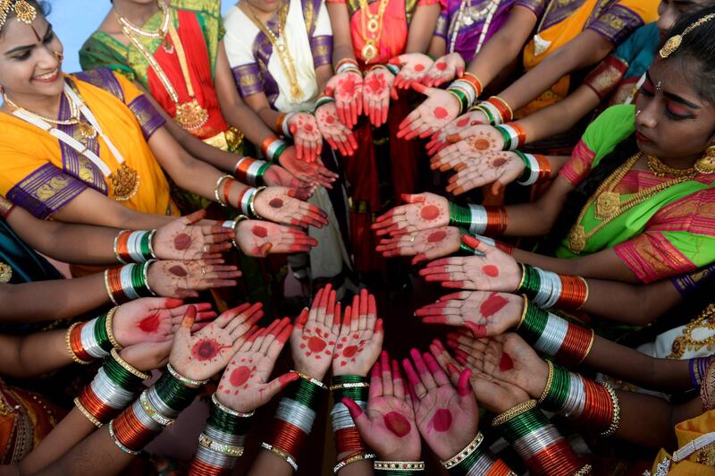 Girls wearing tricolour bangles pose before taking part in an Independence Day ceremony in Secunderabad. AFP